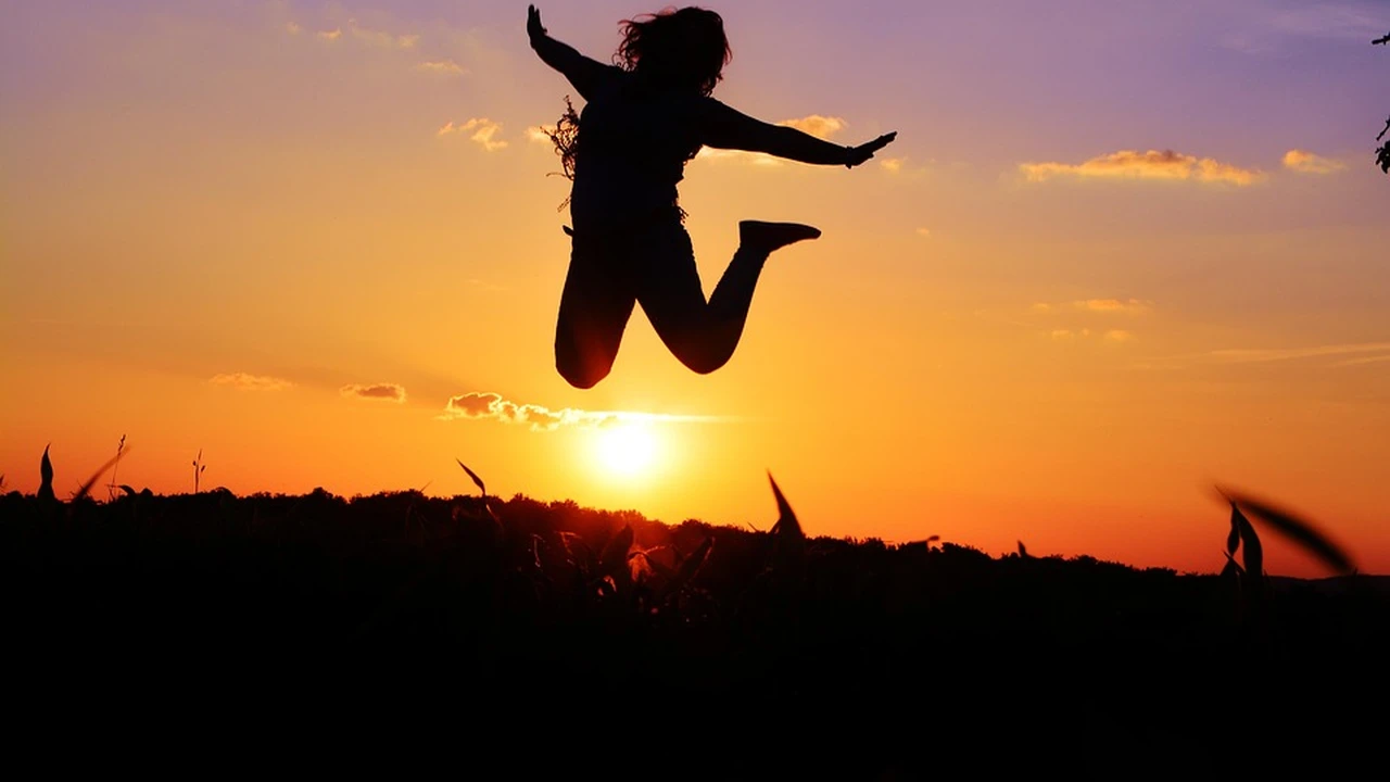 Two mint chocolate milkshakes with whipped cream and green sprinkles.