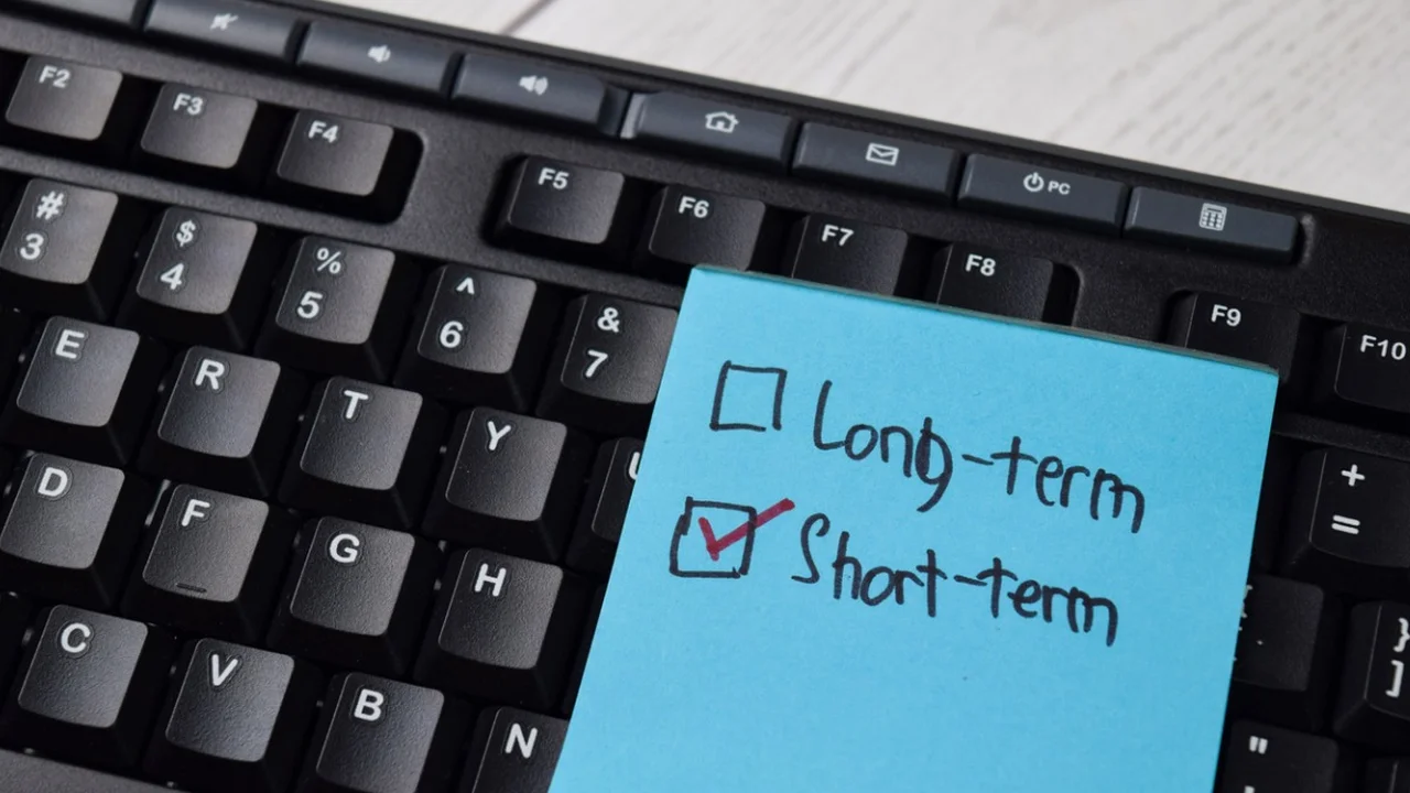 Close up on a plate of mashed potatoes, topped with baked pork chops with cream of mushroom soup, and a side of green beans.