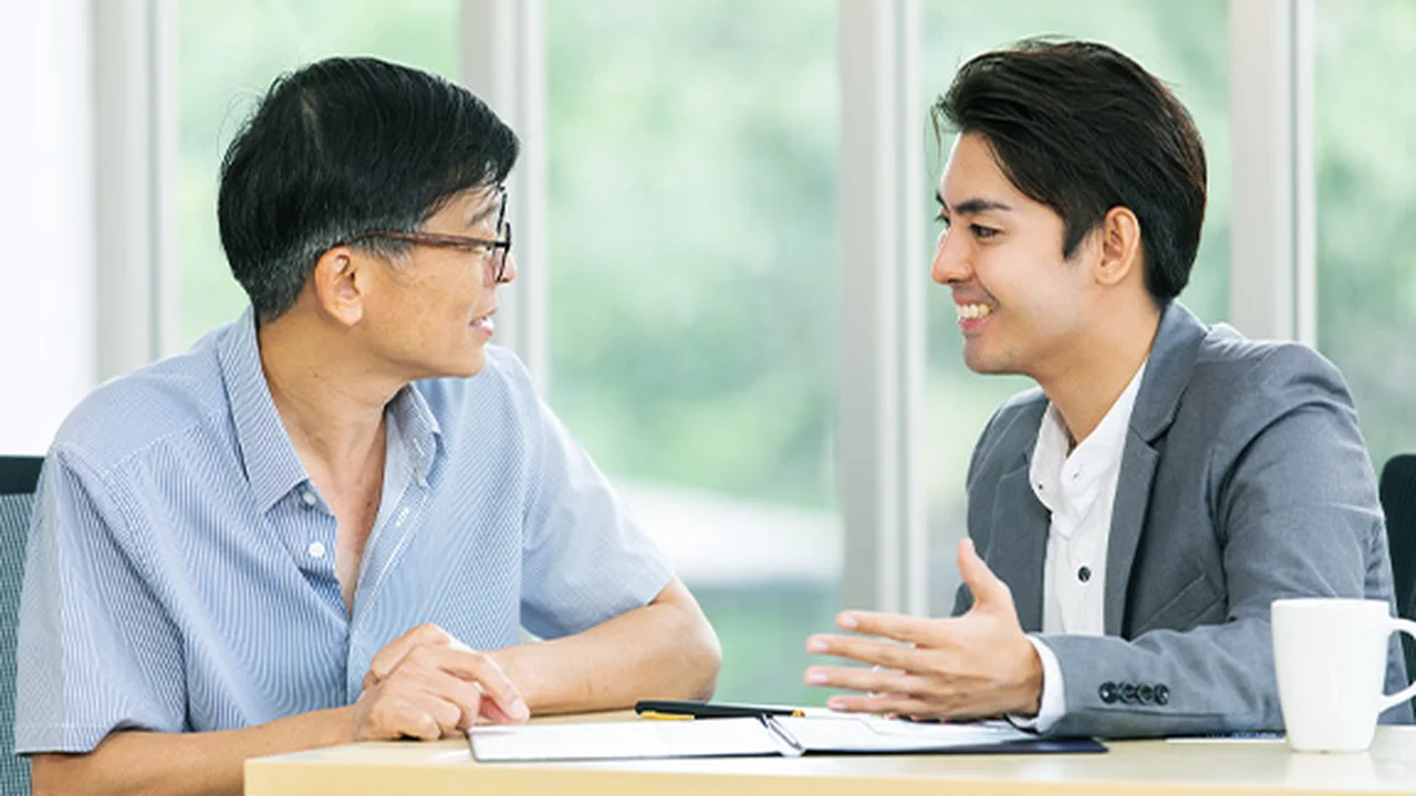 Two mint chocolate milkshakes with whipped cream and green sprinkles.