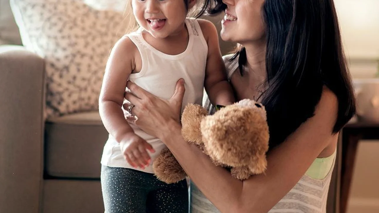 Close up on a plate of mashed potatoes, topped with baked pork chops with cream of mushroom soup, and a side of green beans.