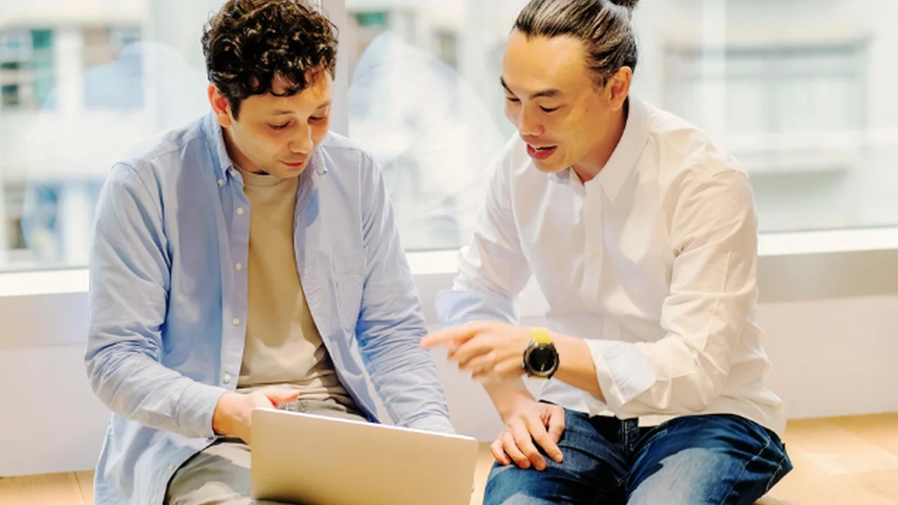 Two mint chocolate milkshakes with whipped cream and green sprinkles.