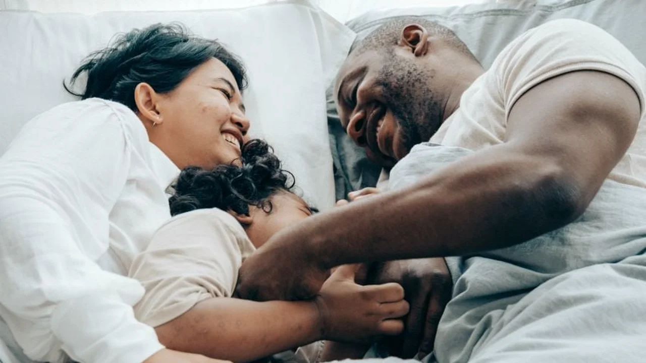 Close up on a plate of mashed potatoes, topped with baked pork chops with cream of mushroom soup, and a side of green beans.